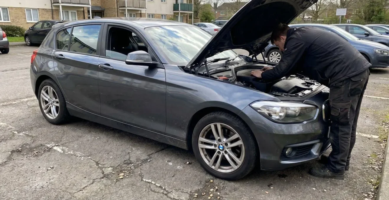 Une personne inspectant le compartiment moteur d